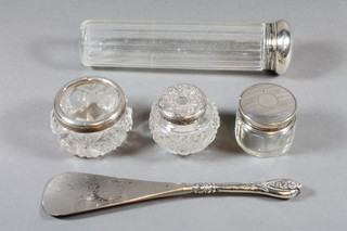 A cut glass faceted pin tray, 2 small cut glass dressing table jars with silver mounts, a circular silver salt with silver mount and a  shoe horn
