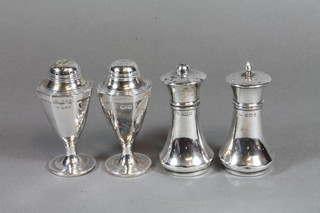 A pair of Edwardian octagonal silver pepperettes, London 1909 and a pair of silver salts and peppers, Birmingham 1919, 3 ozs