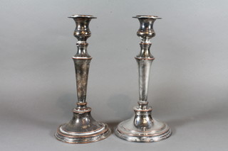 A pair of silver plated candlesticks with bead work borders 11"