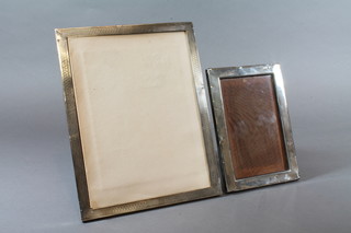 A rectangular silver easel photograph frame with engine turned decoration Birmingham 1931 9" x 7" and 1 other London 1931  6.5" x 4.5"