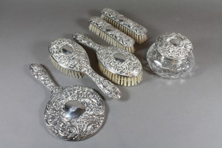 A modern 5 piece filled silver backed dressing table set  comprising hand mirror, pair of hair brushes and pair of clothes  brushes, together with a cut glass dressing table jar with silver lid