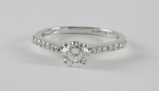 An 18ct white gold engagement/dress ring set a solitaire diamond and diamonds to the shoulders, approx 1ct in total