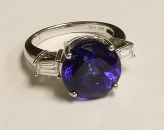 A lady's 18ct white gold dress ring set a tanzanite approx. 10.16ct and with 2 baguette cut diamonds approx 0.63ct to the  shoulders