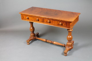 A Victorian walnut side table fitted 2 frieze drawers, raised on a pair of baluster turned supports, platform bases, united by turned  stretcher 29"h x 44"w x 19"d