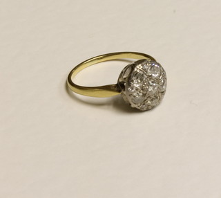 A yellow gold cluster dress ring set diamonds