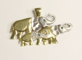 A 2 colour gold pendant in the form of elephants set diamonds  and emeralds