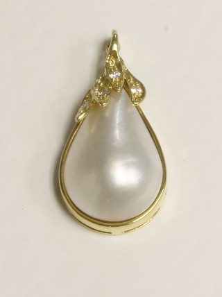 An 18ct gold pendant set a pearl with diamonds