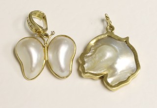 A 14ct gold pendant set diamonds and 2 pearls together with a  gilt metal pendant set a pearl