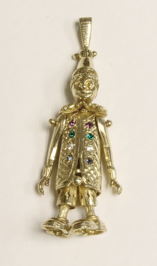 A gold pendant in the form of an articulated clown, the body set diamonds and emeralds, approx. 10.1 grams   ILLUSTRATED