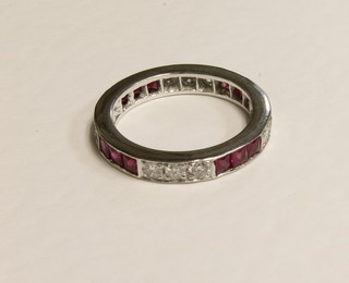 An 18ct white gold eternity ring set rubies and diamonds