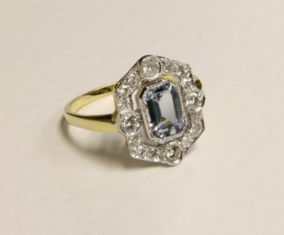 An 18ct yellow gold dress ring set a rectangular cut aquamarine  surrounded by diamonds