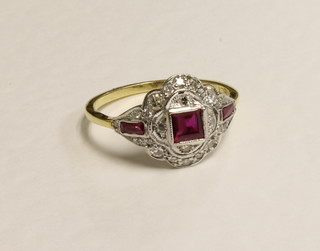 An 18ct yellow gold dress ring set a square cut ruby and baguette cut rubies to the shoulders supported by diamonds