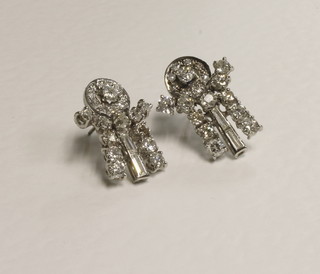 A pair of white gold and diamond earrings set rows of circular  cut and baguette diamonds