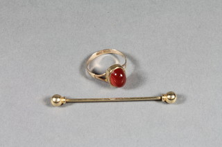 A 9ct gold dress ring set an orange cabouchon cut stone and a  gold tie pin