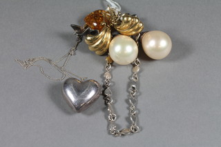 An amber pendant, a pair of silver and simulated pearl earrings,  a pair of gilt metal earrings, a silver chain and a heart shaped  pendant