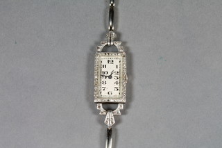 A ladies cocktail wristwatch with silvered dial, Arabic numerals contained in an 18ct gold case set diamonds, by the Goldsmiths  & Silversmiths Co. with 18ct white gold integral bracelet   ILLUSTRATED