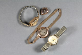 3 ladies wristwatches contained in gold cases and a gold heart  shaped locket