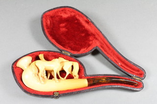 A carved cheroot holder in the form of 2 standing horses with "amber" mouthpiece, cased,