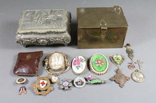 An Indian brass box containing a shell carved cameo portrait brooch, a small collection of costume jewellery and an embossed  metal box