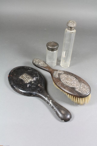A pierced silver backed hand mirror, a wooden and silver  mounted hair brush, a glass pin jar with silver lid and 1 other