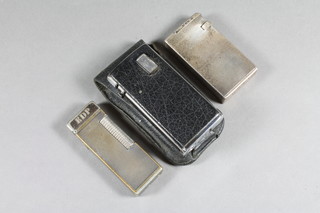 An Art Deco silver cigarette lighter with engine turned decoration London 1936, a Dunhill silver plated lighter and a Ronson  Varaflame Electronic lighter