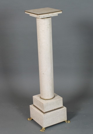 A grey granite stepped pedestal raised on gilt paw feet 42"h