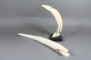 A carved ivory figure of a crocodile 19" and do. bird 10"