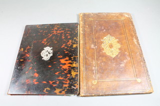 A Victorian tortoiseshell blotter with silver monogram mount to  the centre, 11.5" x 9.5" and a leather blotter the interior with  frontispiece marked S.Ionnis Chrysostomi 14" x 9"