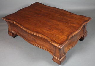 A reproduction stained beechwood coffee table of serpentine  waisted form, having a shaped rectangular top above 2 end  drawers, raised on block feet 18"h x 54"w x 38"d
