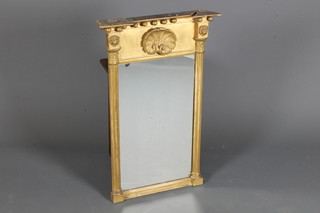 An early 19th Century gilt gesso pier glass of architectural form, having jewelled cornice above a frieze centred with scallop shell  and flanked by lion mask mounted reeded split pilasters, plinth  base 29.5"h x 18"w