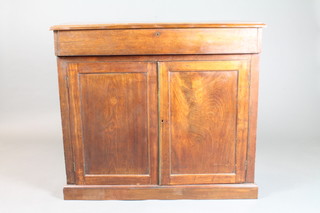 A George III mahogany chiffonier fitted a drawer above panelled doors, raised on a platform base 37"h x 41"w x 14.5"d