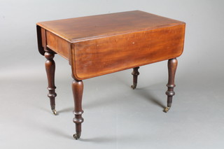 A Victorian mahogany Pembroke table fitted a drawer, raised on turned supports, brass caps and casters 36"h x 28.5"w x 22"d