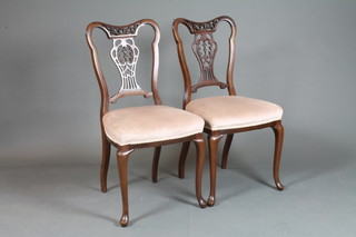 A set of 6 Victorian mahogany dining chairs with pierced vase shaped backs and upholstered seats, raised on cabriole supports