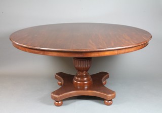A circular Victorian style mahogany pedestal dining table, raised  on baluster column support, tripod base, 62"d