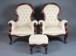 A pair of Victorian style mahogany show frame armchairs, raised on cabriole supports, together with a matching footstool on  turned and reeded supports