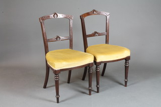 A set of 6 late Victorian carved mahogany rail back dining chairs  with upholstered seats, raised on turned supports