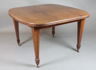 A late Victorian oval inlaid mahogany dining table with 2 extra leaves, raised on square tapering supports ending in brass caps and casters 28"h x 83"l x  47.5"w