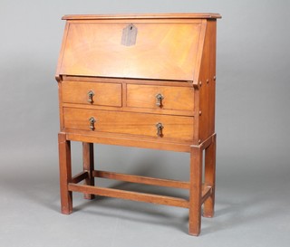 An Art Nouveau mahogany student's bureau, the fall front  enclosing a well fitted interior above 2 short and 1 long drawers,  raised on square supports with box frame stretcher 42"h x 32"w x  12"d