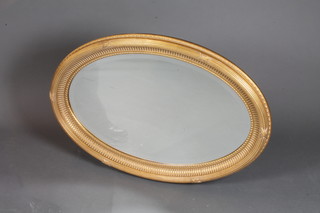 A Regency style oval bevelled plate wall mirror contained in a gilt frame 37"h x 25"w
