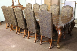 An Italian style walnut dining suite comprising rectangular  extending dining table with 1 extra leaf, raised on cabriole  supports 31"h x 92"l x 51"w - 122"l when extended, together  with 10 high backed dining chairs with X framed stretchers