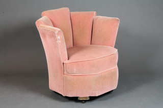 An Art Deco armchair upholstered in pink material