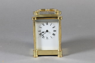 An early 20th Century French gilt brass carriage timepiece of architectural form, having Roman painted dial set 8 day  movement with lever escapement 5.5"h x 3"w x 2.75"d