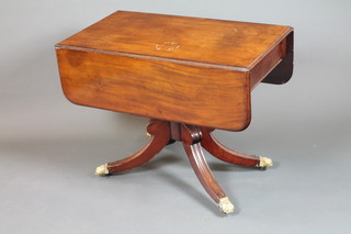 A George IV mahogany pedestal Pembroke table fitted end  drawer, raised on a turned column support, quadripartite base  with brass claw caps and casters 28.5"h x 36"w x 42"d