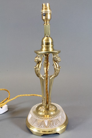 An Empire style gilt metal and cut glass table lamp raised on 3 lion supports 14"