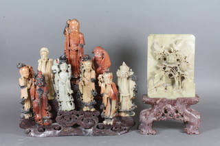 A Chinese carved soap stone table screen with floral and bird decoration 8", together with a Chinese carved soap stone figure  group of 8 various deities