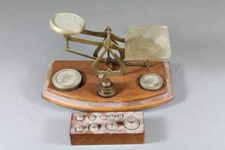A pair of brass letter scales complete with weights together with a set of postal weights