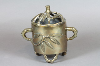 A Chinese cylindrical bronze twin handled censer, the base with seal mark 4" together with a pair of brass metal candlesticks 7"   ILLUSTRATED