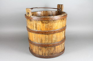 A reproduction wooden and iron coopered well bucket
