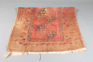 A red ground Afghan rug decorated octagons to the centre 83" x  44"