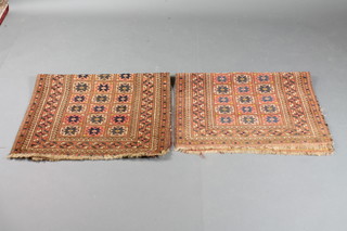 A pair of red ground Afghan rugs with 33 octagons to the centre 44" x 31"